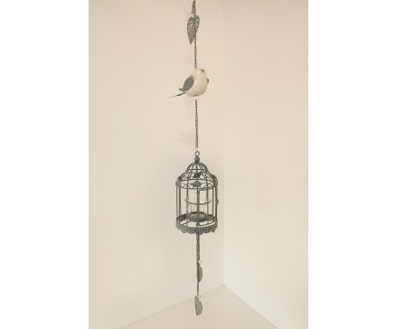 M191913 Metal hanging decoration. Klein porseleinen vogeltje met hartjes en blaadjes en klein kooitje voor theelicht. Donkergrijs. Lengte : 86 cm. Per 4 stuks verpakt. Prijs is per 4 stuks.